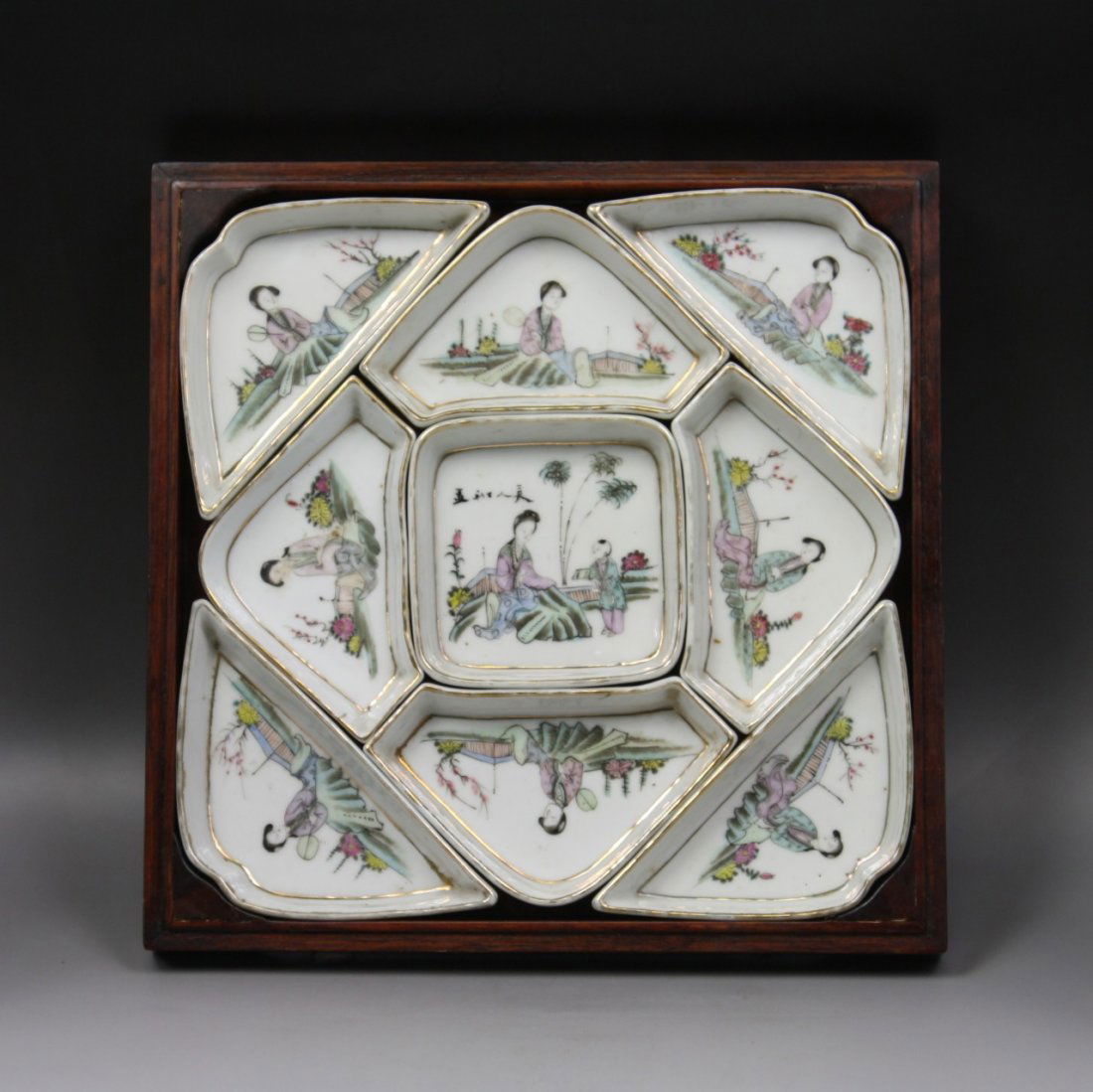 A Set Of Chinese Gilt Famille Rose Dishes: A Set Of Chinese Gilt Famille Rose Dishes: all nine dishes are of three different shapes, each dish has either a lady or kid playing in courtyard, in matching wood case, Minguo Period; Size: L: 11" W: