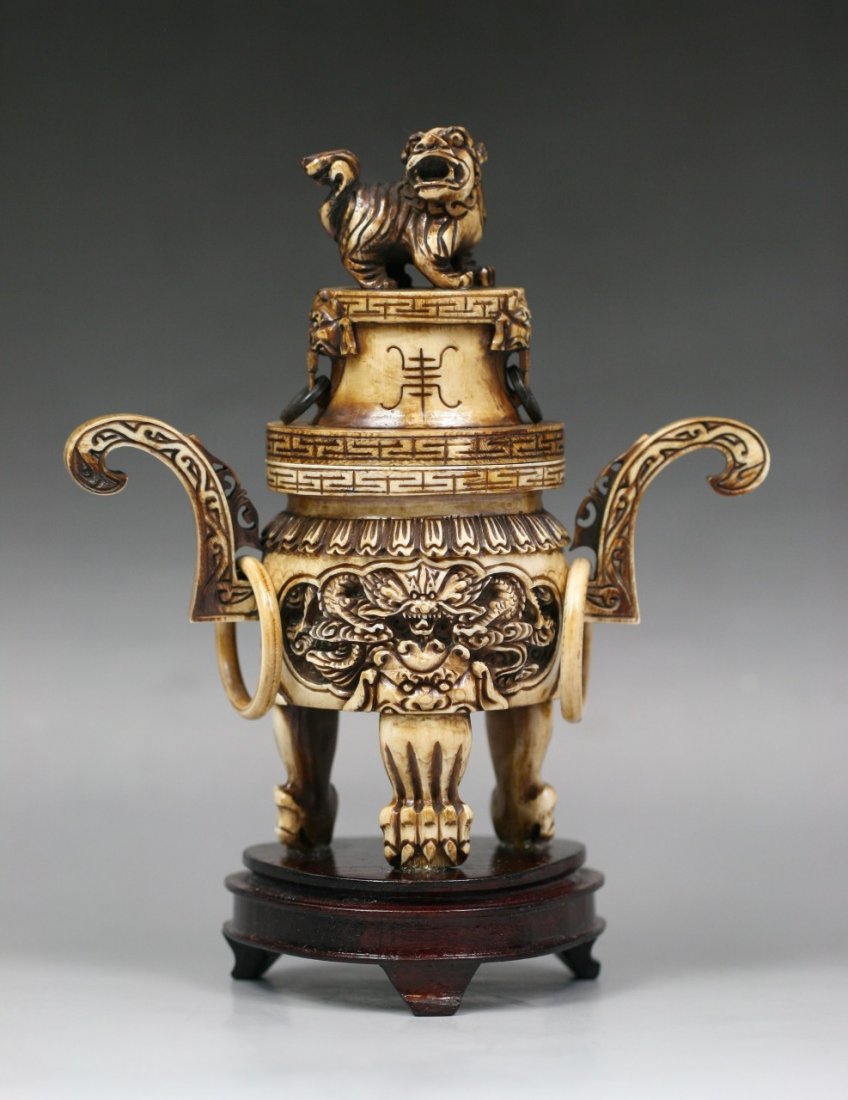 Chinese Finely Carved Tripod Footed Ivory Censor: Chinese finely carved tripod footed inked ivory censor: with flaring handles and foo lion final on cover, carved with dragon panels and beast feet, with two pairs of loose rings, character mark carved