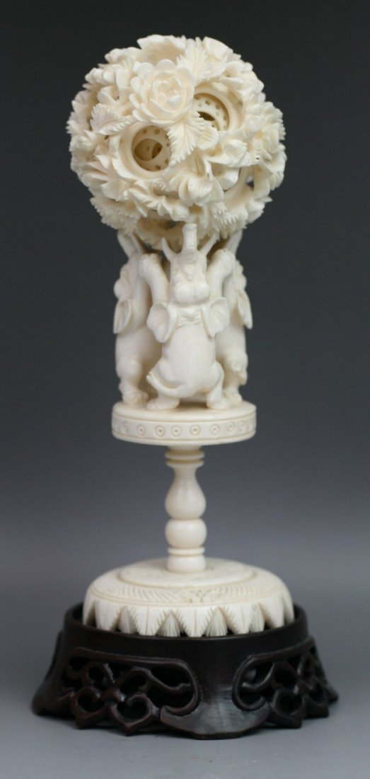 Chinese Antique Carved Ivory Puzzle Ball: Chinese Carved Ivory Puzzle Ball: carved with blossoming flowers to the exterior, and at least eight inner concentric openwork balls supported by three elephants, on a pedestal stand, with matching wo