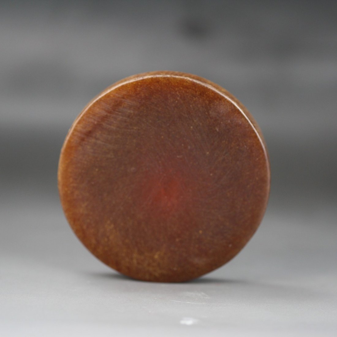 A Chinese Carved Rhino Horn-Like Pendant: A Chinese Carved Horn-Like Pendant: of circular shape, of very attractive warm brown tone with grain, probably rhino horn; Size: D: 68mm(2-5/8")