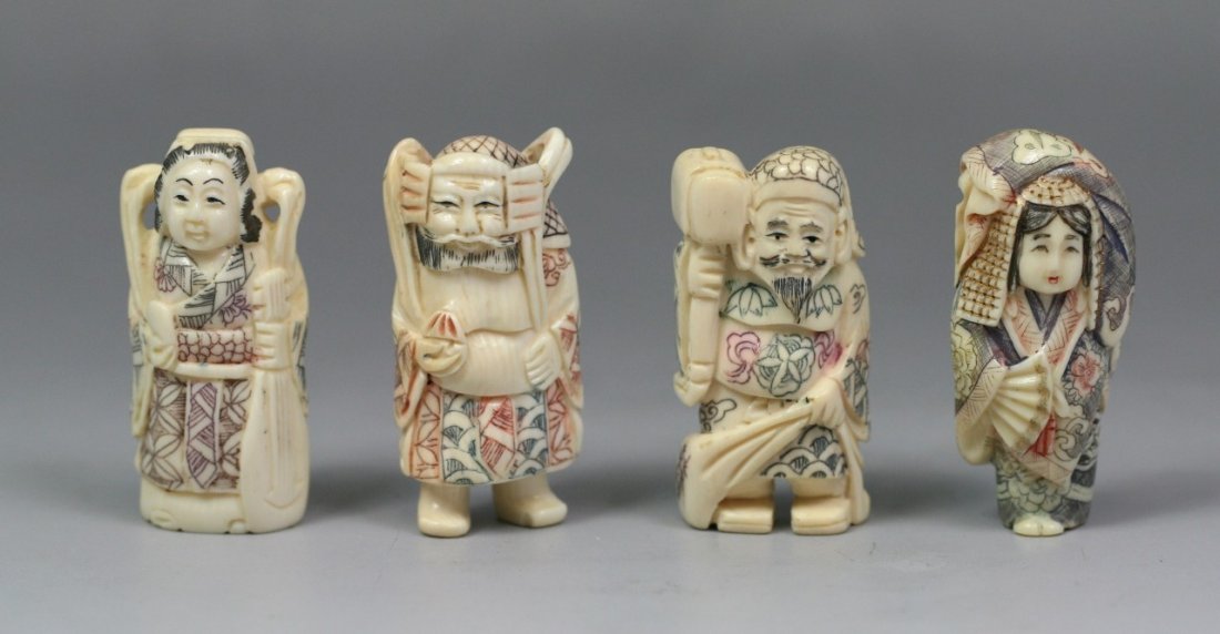 Four Carved Polychrome Ivory Netsukes: Four Carved Polychrome Ivory Netsukes: two women standing in robes, one with a fan in her right hand the other woman with an instrument in her left hand, two men standing, one bearded holding a tool w