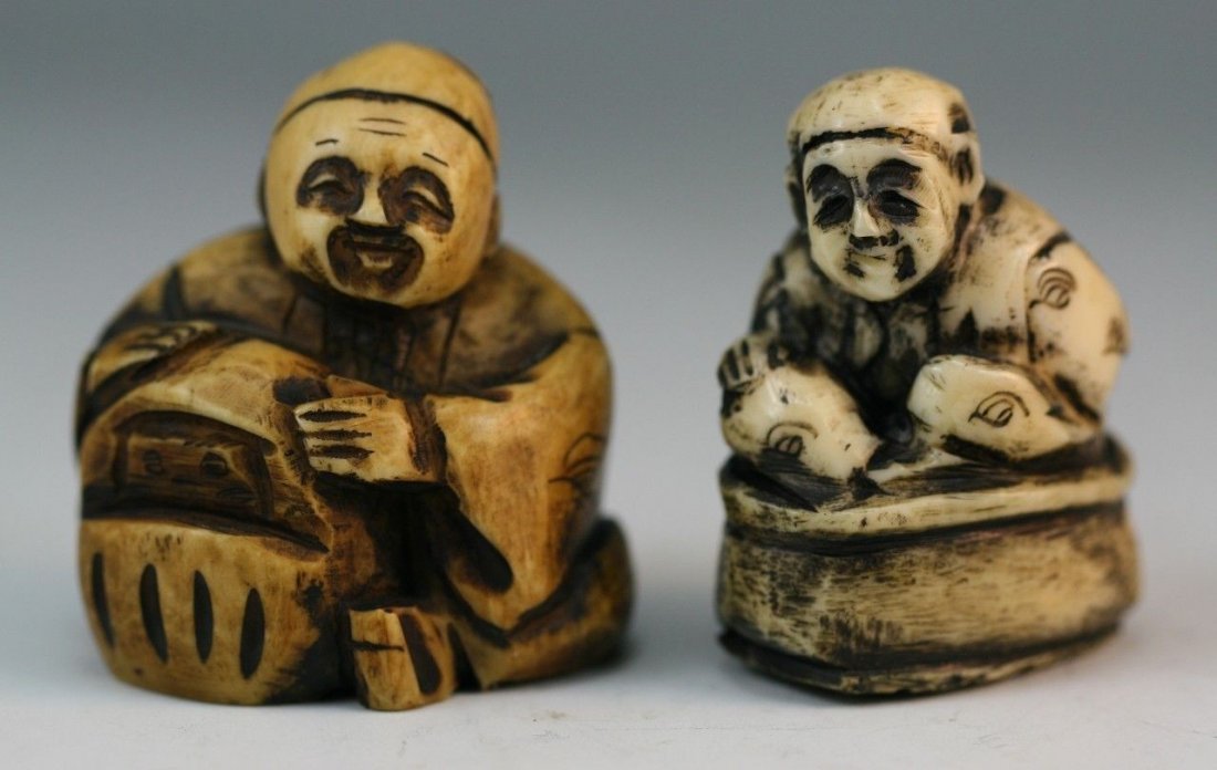 Two Carved Antique Ivory Netsuke: Two carved ivory netsuke: one man smiling while sitting with his legs crossed on a rock, the other is a man sitting with a box; Size: H: 1-5/8" (Higher)