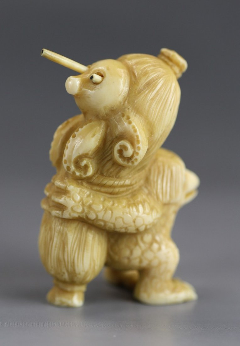 An Antique Ivory Netsuke: Frog: An Antique Ivory Netsuke: A frog holding a basket while a octopus is sitting on its back. Signature on the bottom; Size: H: 2"
