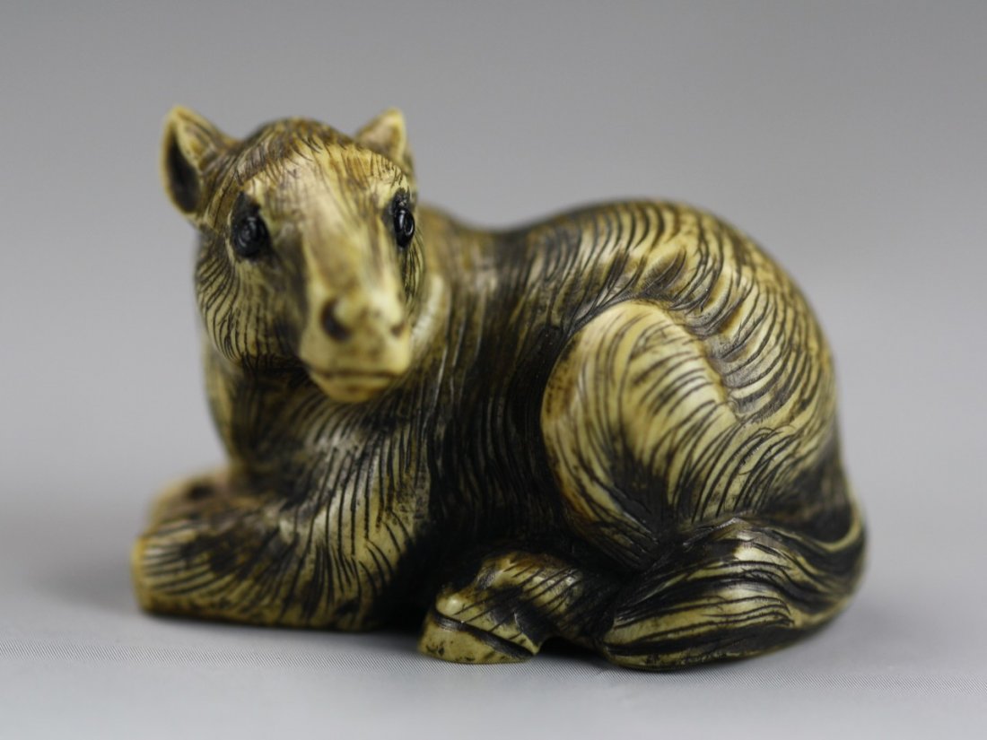 An Antique Ivory Netsuke: Horse: An Antique Ivory Netsuke: A highly detailed horse in a resting position. Signature on the bottom; Size: H: 1"; L: 1-1/2"