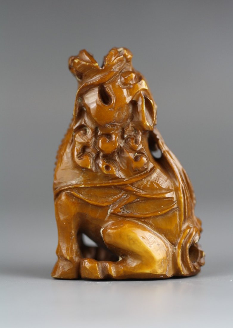 An Antique Ivory Netsuke: Shi-shi: An Antique Ivory Netsuke: A finely detailed Shi-shi sitting with its head looking up and mouth open; Size: H: 2-1/8"