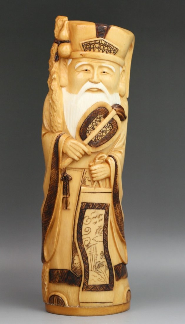 Chinese Antique Carved Polychrome Ivory: Chinese antique carved polychrome ivory God of Longevity: standing in robes while holding a fan in right hand and a bag in left hand; with two character "Da Ming" on the base; Size: H: 9"