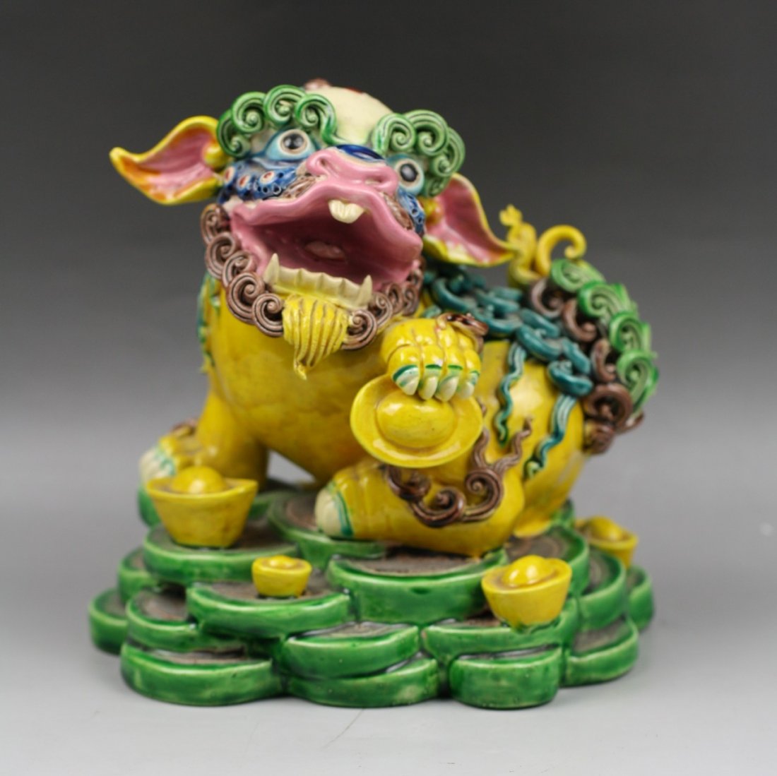 A Fine Chinese / Taiwan Jiaozhi Pottery Lion: A Fine Chinese / Taiwan Jiaozhi Pottery Lion: well and detialed moulded as a lion of seated position on plinth with head turned to left, applied overall with green and yellow glaze, Middle of 20th Cen