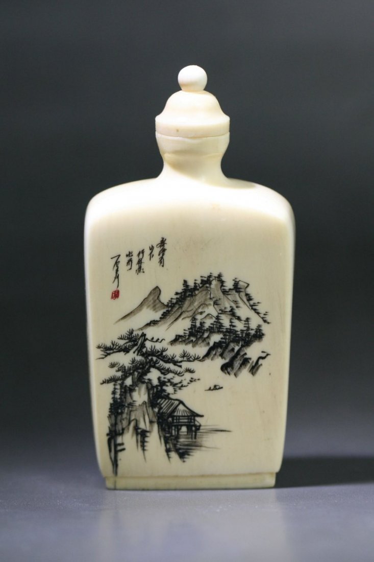 A Chinese Carved & Engraved Ivory Snuff Bottle: A Chinese Carved & Engraved Ivory Snuff Bottle: of rectangular section, finely polished and scrimmed on one side with mountainous landscape together with elaborate calligraphy, the other side engraved