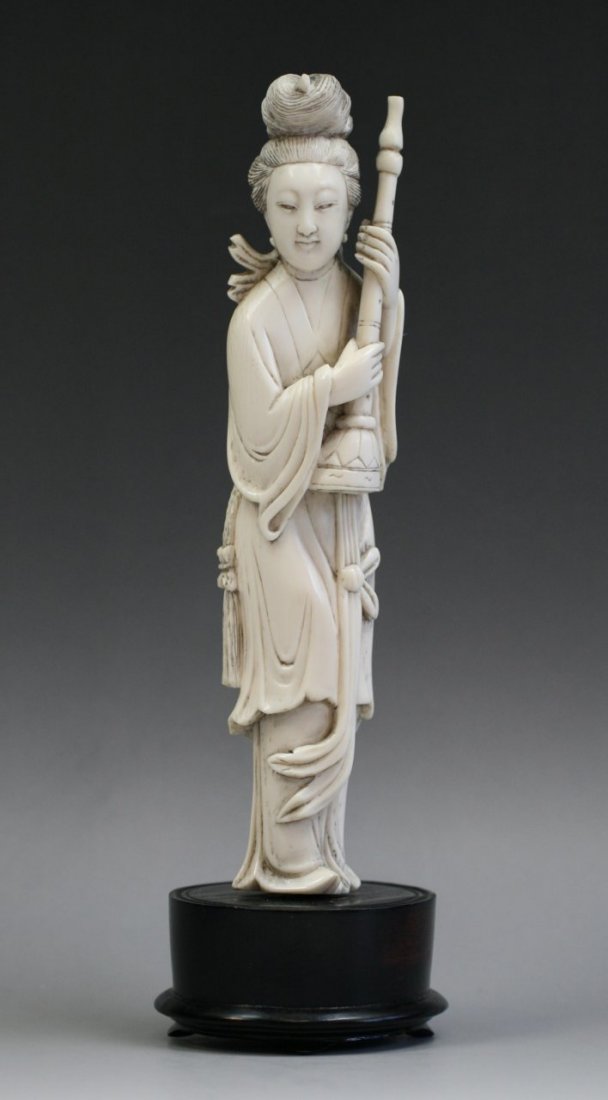 A Chinese Antique Ivory Beauty: A Chinese Antique Ivory Beauty: finely carved as a beauty holding an instrument over her shoulders standing in swaying robes, sign Of Yuan Zhong on the lower part, Late Qing Dynasty; Size: H: 9"