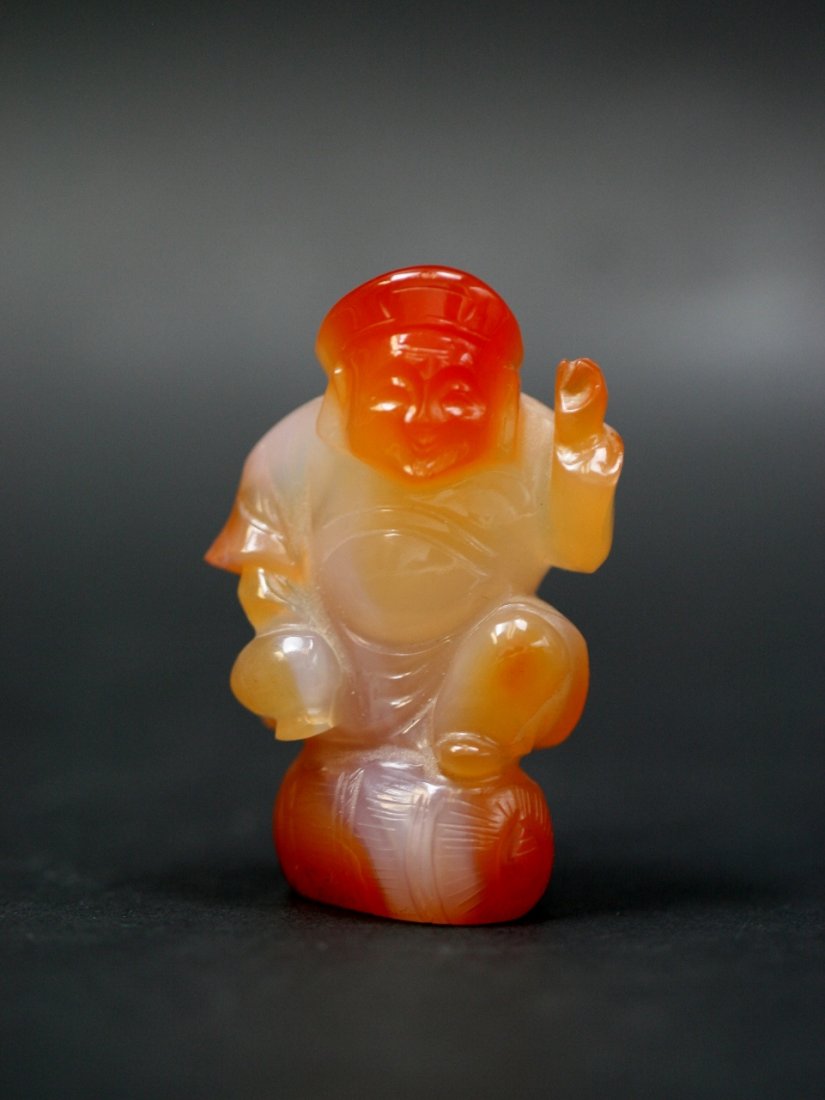 A Chinese Carnelian Agate Carving Of Figure: A Chinese Carnelian Agate Carving Of Figure: well carved and polished from the agate with semi-translucent warm red tone, circa 1900; Size: H: 2-1/4"