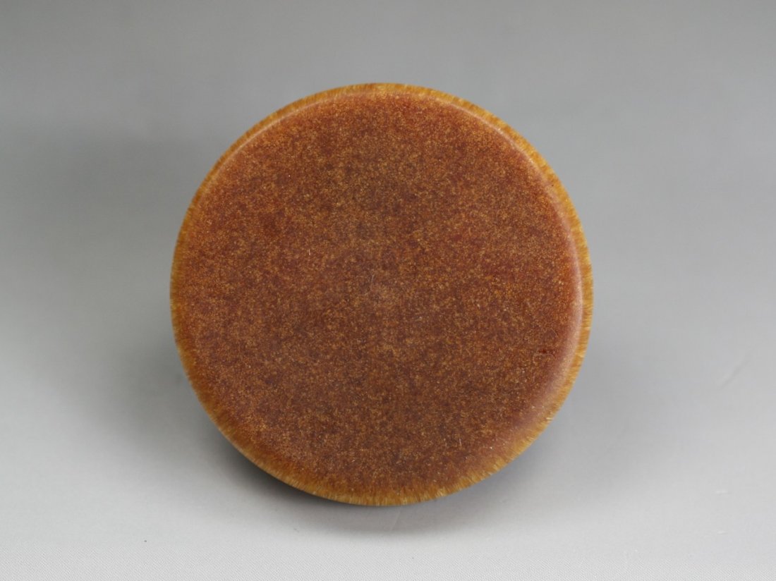 A Chinese Antique Carved Horn Pendant: A Chinese Antique Carved Horn Pendant: of circular form, finely carved from the rhinoceros horn or like with dark reddish brown tone; Size: D: 2-1/2"