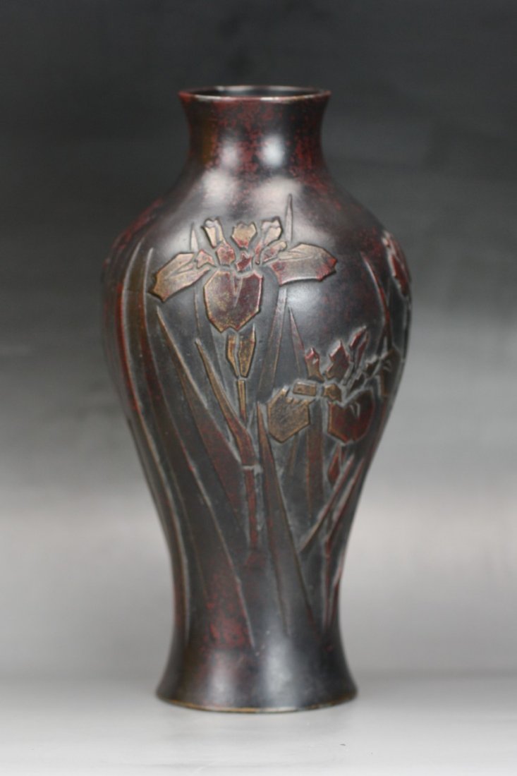 A Japanese Antique Carved Bronze Vase: A Japanese Antique Carved Bronze Vase: molded as shouldered form with waisted base rising to slightly flaring rim, carved around the body with flowers with foliages, Late 19th Century; Size: H: 10"