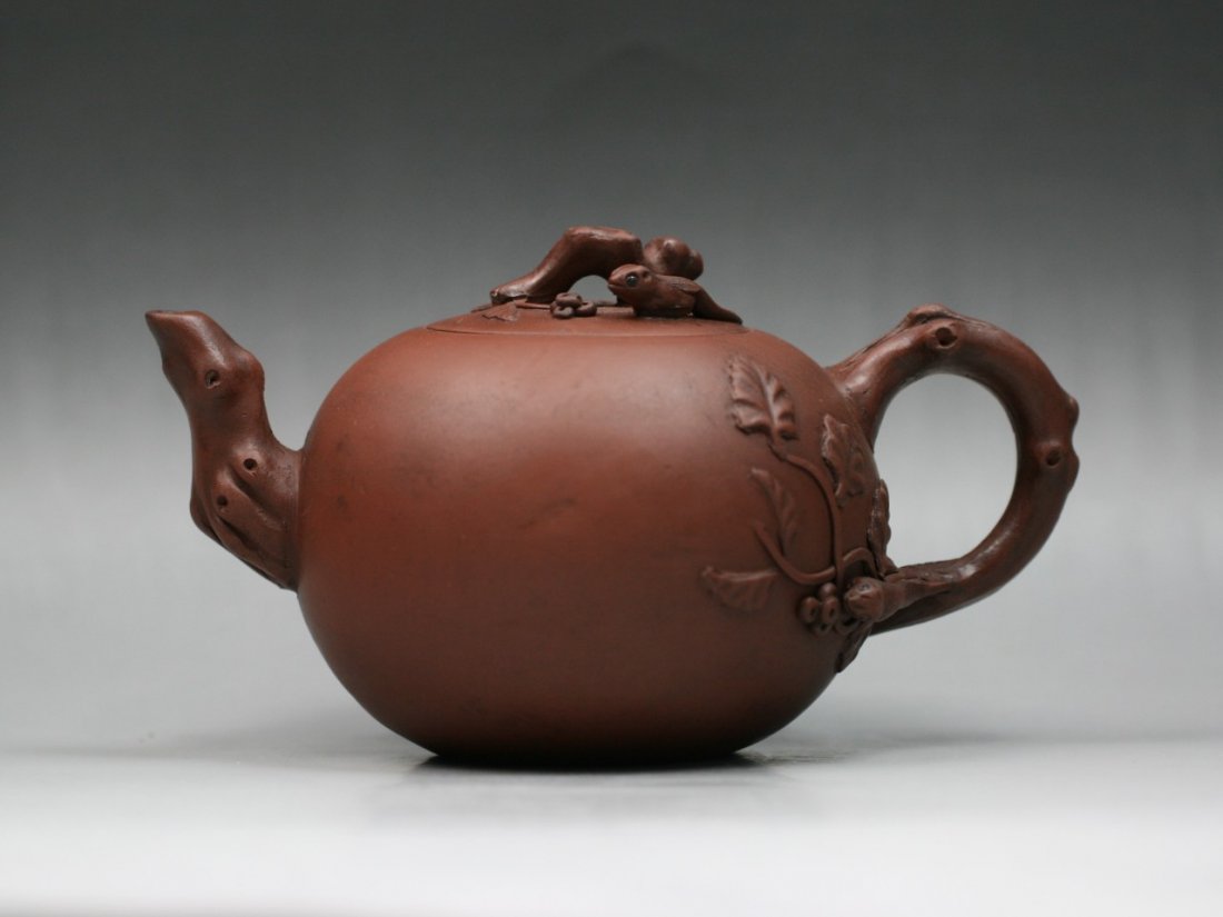 A Fine Yixing Purple Clay Zisha Teapot: A Fine Yixing Purple Clay Zisha Teapot: well potted of rounded form with leafy stem shaped handle and stout on the opposite, the fitted rounded cover with animal shaped finial on top, with the seal of