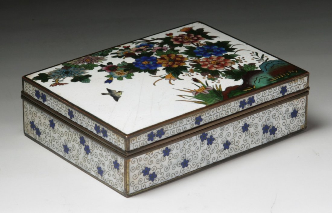 A Japanese Silver Ando Cloisonne Box With Cover: A Japanese Silver Ando Cloisonne Box With Cover: with square form, decorated with the scene of bird flying amongst blooming trees, all reserved on a bight white ground, of early 20th Century; Size: L:
