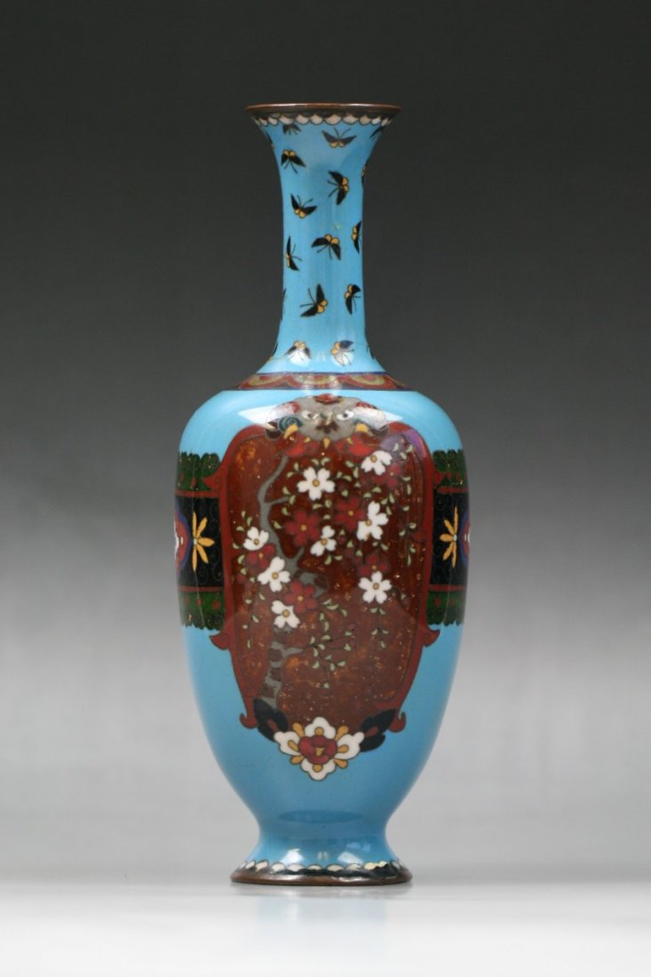 A Japanese Antique Silver Ando Cloisonne Vase: A Japanese Antique Silver Ando Cloisonne Vase: of tapered shouldered form with long and slender neck, reserved on a royal blue ground, of 19th Century; Size: H: 9-1/2"