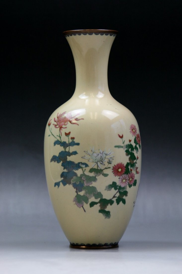 A Japanese Antique Silver Ando Cloisonne Vase: A Japanese Antique Silver Ando Cloisonne Vase: of elegant tapered shouldered form with slender neck rising to slightly flared rim, finely enamelled around with bird amid blooming trees, reserved on a