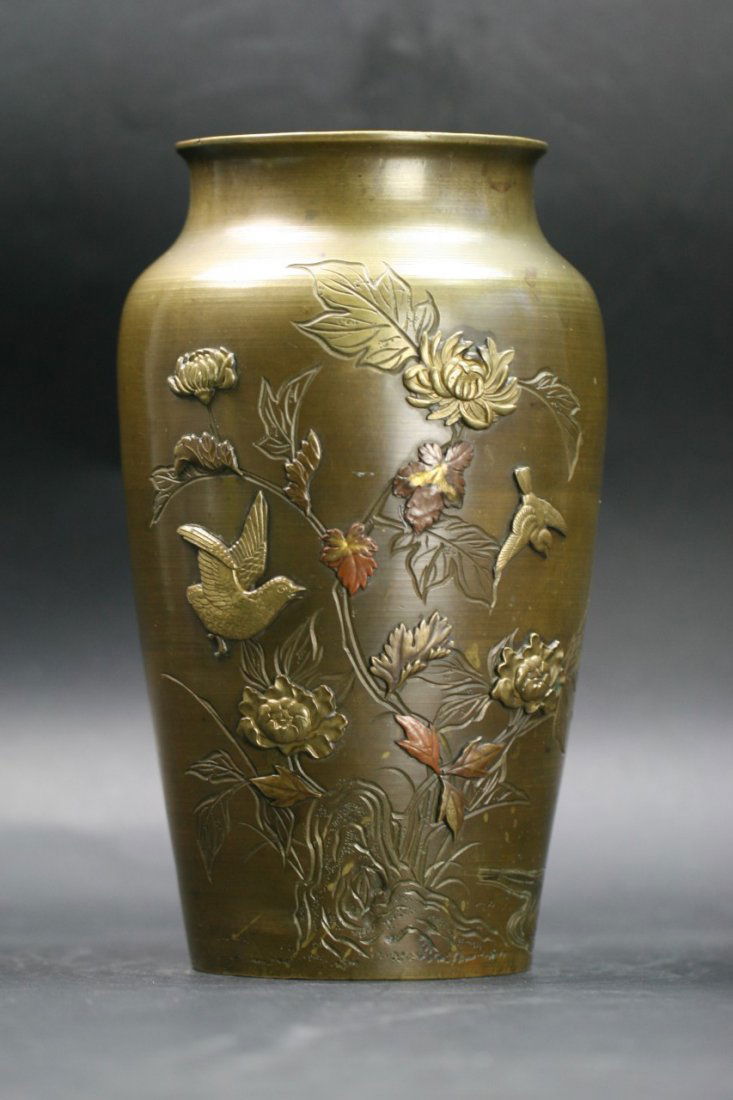 A Japanese Antique Bronze Vase: A Japanese Antique Bronze Vase: well molded in high relief as birds in flight amongst blooming trees, of shouldered body with wide neck, of late 19th Century; Size: H: 11"