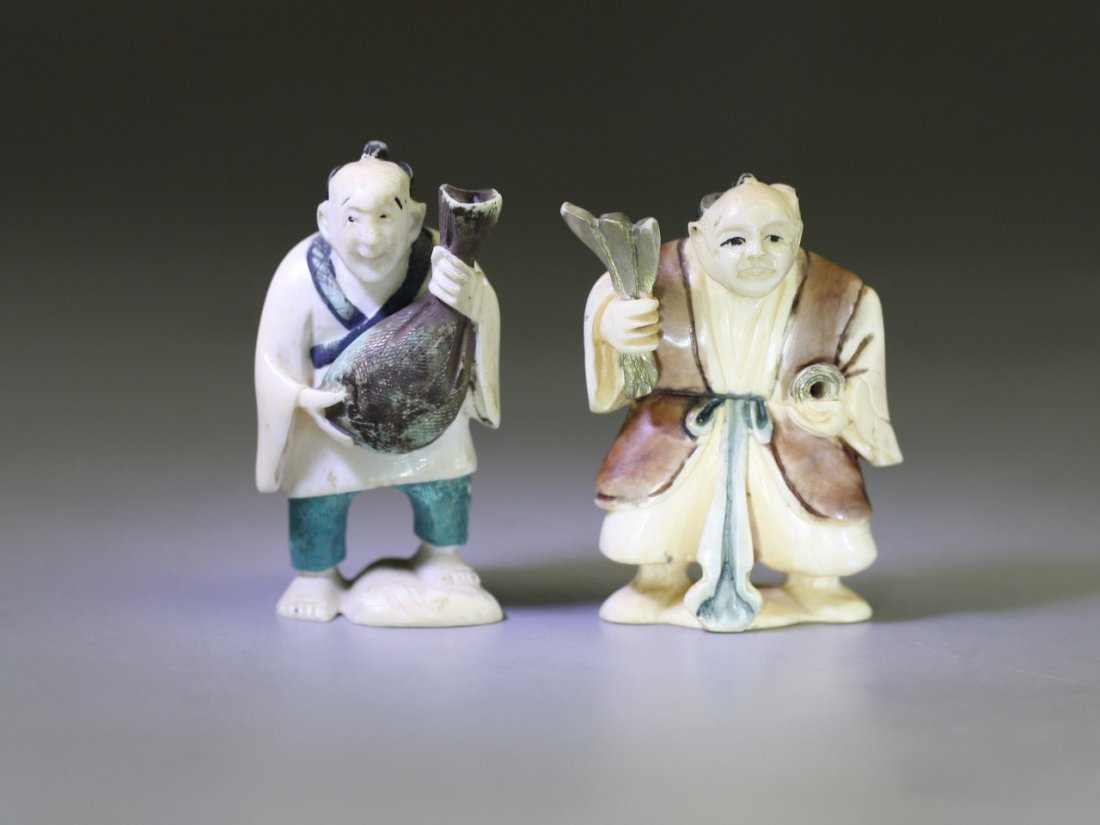 Pair of Antique Polychrome Ivory Netsukes: Pair of Antique Polychrome Ivory Netsukes: two men standing while holding tools in their hands, both signed on the bases, 19th Century; Size: H: 2-1/8"