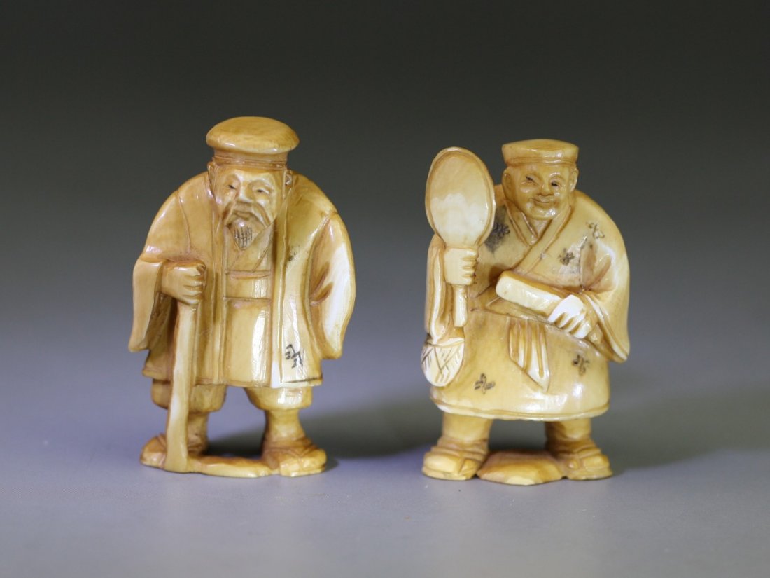 Pair of Antique Ivory Netsukes: Figures: Pair of Antique Ivory Netsukes: two men standing while holding tools in their hands, both signed on the bases, 19th Century; Size: H: 2-1/8"