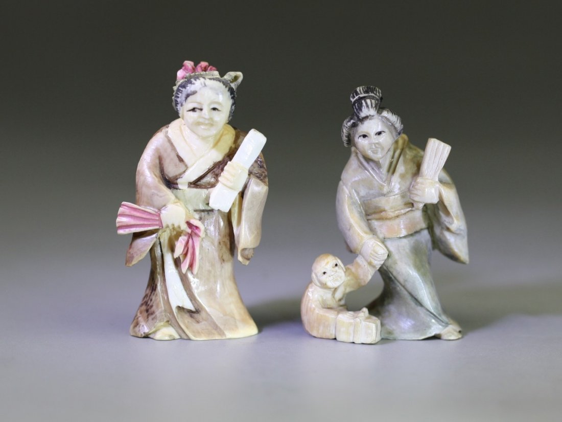 Pair of Antique Polychrome Ivory Netsukes: Pair of Antique Polychrome Ivory Netsukes: two ladies standing in robes, one holding fans in her two hands, while another lady hold a fan in her left hand, and taking a monkey in her right hand, both 
