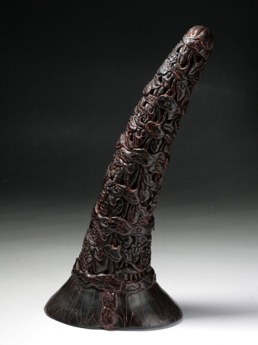 A Chinese Antique Rhinoceros Horn Carving: A Chinese Antique Rhinoceros Horn Carving: intricately carved and unusual, the horn ranging from deep brown to caramel tone, probably of early Qing Dynasty; Size: L: 13-1/2" with D: 5-3/4"