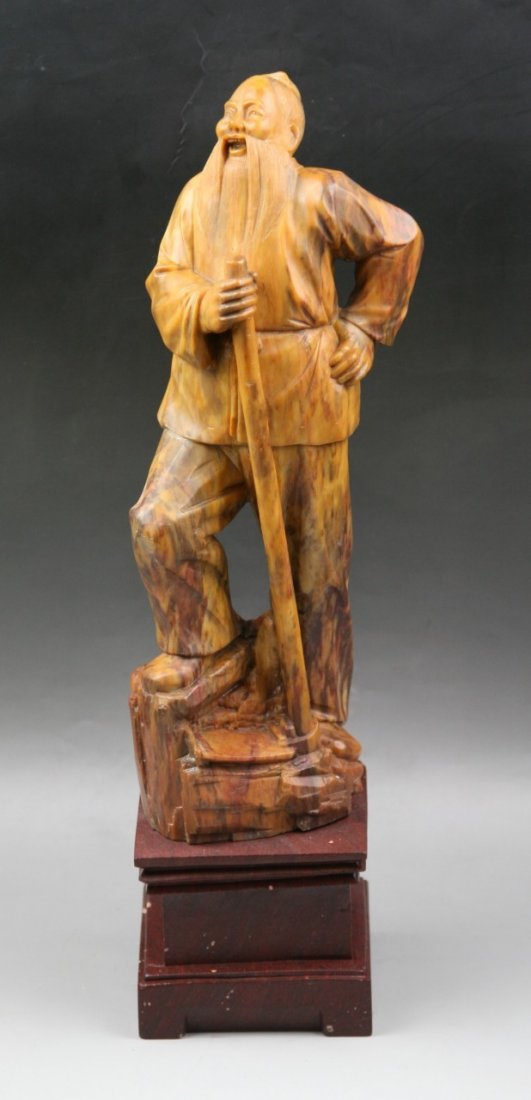 A Chinese Carved Soapstone Figure: A Chinese Carved Soapstone Figure: well carved from the soapstone with warm brown tone as a old man standing on rockery; Size: H: 16-1/4"