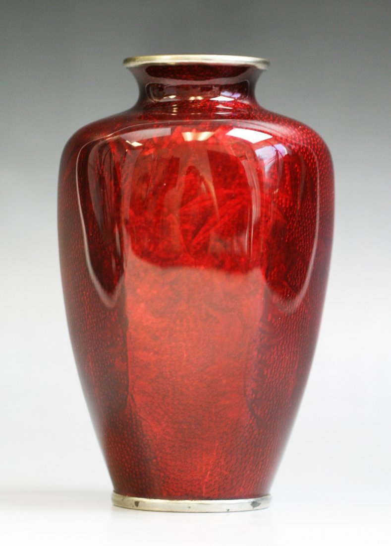 A Japanese Antique Silver Ando Cloisonne Vase: A Japanese Antique Silver Ando Cloisonne Vase: of rounded body with short neck, all reserved on a deep red ground, of 19th Century; Size: H: 6"