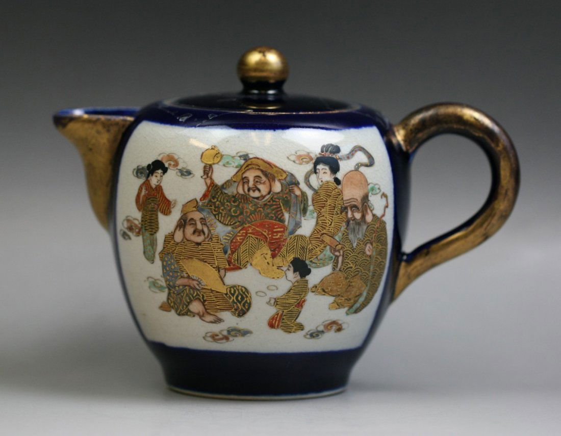 A Japanese Antique Satsuma Gilt Teapot: A Japanese Antique Satsuma Gilt Teapot: with short spout opposite to the C shaped handle, signed on the base, late 19th century; Size: H: 4-1/2"; L: 6"