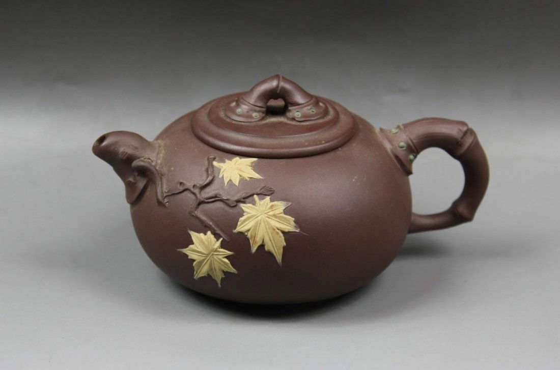 A Chinese Zisha Teapot: A Chinese Zisha Teapot: signed by the artist on the base and inside the cover; Size: L: 5-3/4"