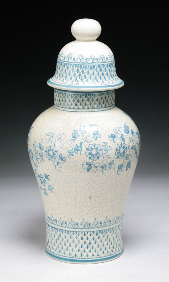 European Antique Crackle-Glazed Covered Temple Jar: Unusual European antique temple jar in baluster form with domed cover : with the design of blue flower blossoms amid scrolling foliages on creamy crackle-glazed ground; late 19th/early 20th century; (
