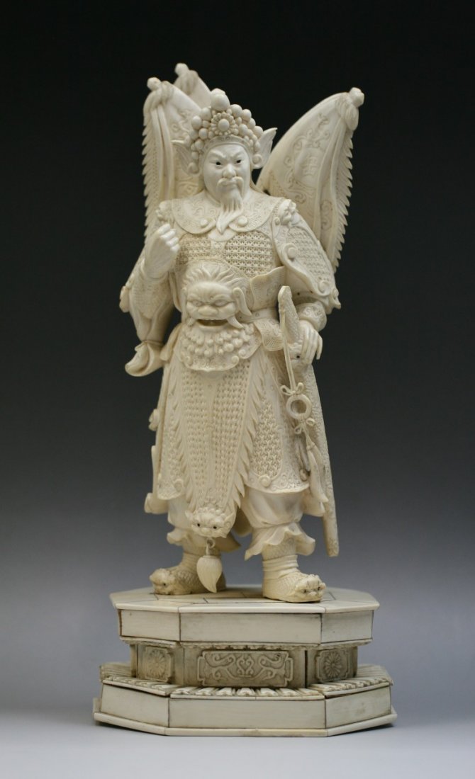 A Chinese Ivory Statue Of Yue Fei: 象牙雕岳飛立像 A Chinese Ivory Statue Of Yue Fei: well carved as Yue, Fei wearing a fully decorated armor while standing on a octagonal plinth, of Minguo Peri