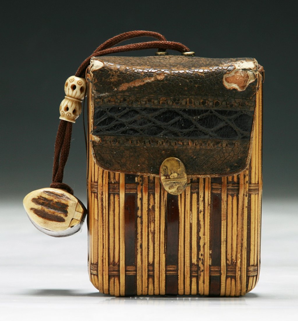 A Japanese Antique Bamboo Waved Wallet: A Japanese Antique Bamboo Waved Wallet: bone carved beads hanging from an attached rope, of 19th Century; Size: L: 4"