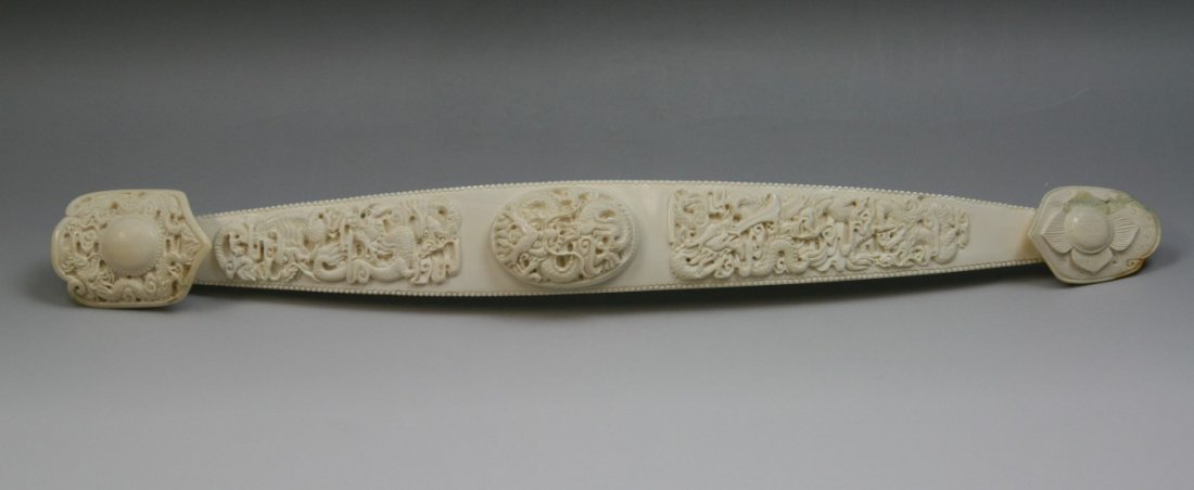 A Chinese Antique Carved Ivory Ruyi Scepter: A Chinese Antique Carved Ivory Ruyi Scepter: very intricately carved, Chinese ivory ruyi scepter, has a long and slightly undulated handle decorated with three interwining dragon amid swirling clouds,