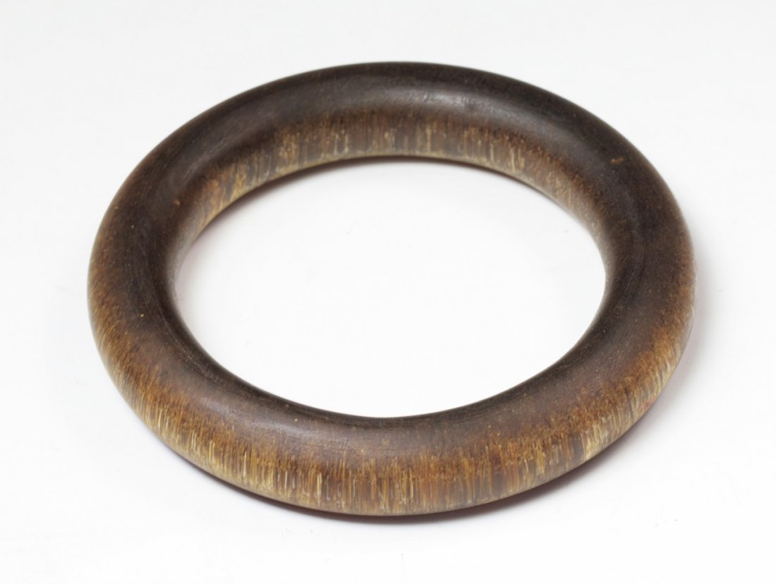 A Rare Chinese Antique Rhinoceros Horn Or Like Bangle: A Rare Chinese Antique Rhinoceros Horn Or Like Bangle: of circular form, carved from the horn with dark brown tone with attractive grain, probably of Qing Dynasty; Size: D: 3-1/2"