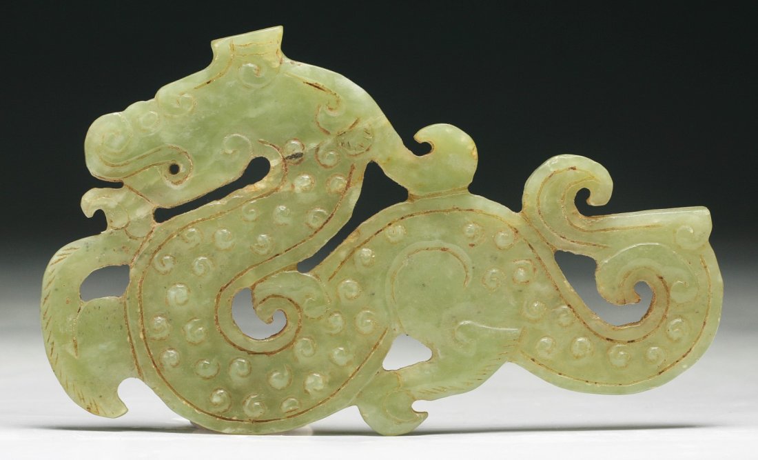 A Chinese Archaic Jade Dragon: A Chinese Archaic Jade Dragon: finely carved as a Chinese archaic dragon in flight, probably of Warring Period or Han Dynasty; Size: L: 4-3/4"