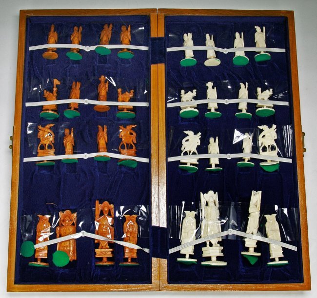 A Complete Set of Chinese Carved Ivory Chess: A Complete Set of Chinese Carved Ivory Chess: all pieces present, the opposing sides of white ivory and sienna dyed ivory are all solid carved pieces all raised on plinths, very good condition, in woo