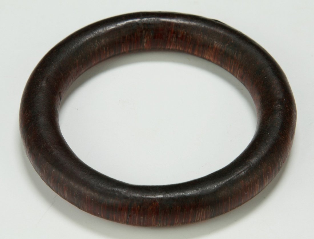 A Chinese Antique Carved Horn Bangle: A Chinese Antique Carved Horn Bangle: of circular form, carved from the rhinoceros horn or like with deep brown tone; Size: D: 84mm; Thickness: 13mm