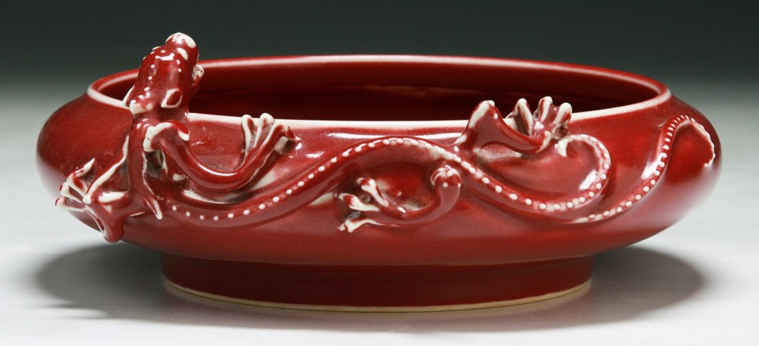 A Chinese Antique Red Glazed Porcelain Brush Washer: A Chinese Antique Red Glazed Porcelain Brush Washer: with a Chi dragon encircling around the rim, the six character 'Qianlong' reign mark painted in blue on the base; Size: D: 7-1/2"