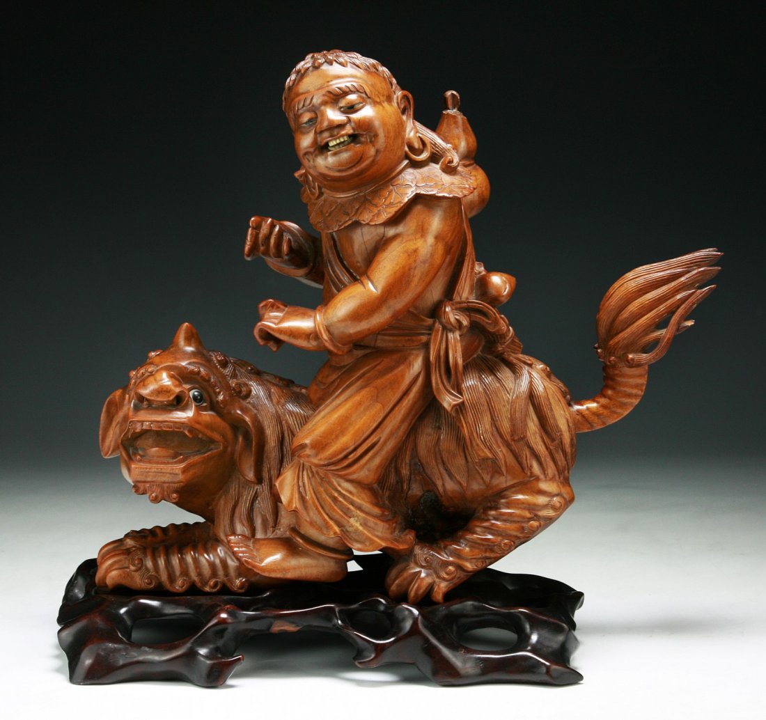 A Chinese Antique Wood Carving: A Chinese Antique Wood Carving: presented on a wood stand, of Minguo period; Size: H: 12"; L: 13-1/2"