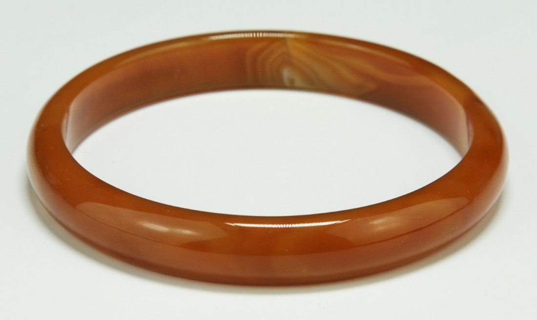 A Chinese Carnelian Agate Bangle: A Chinese Carnelian Agate Bangle; Size: D: 76mm; Thickness: 10mm