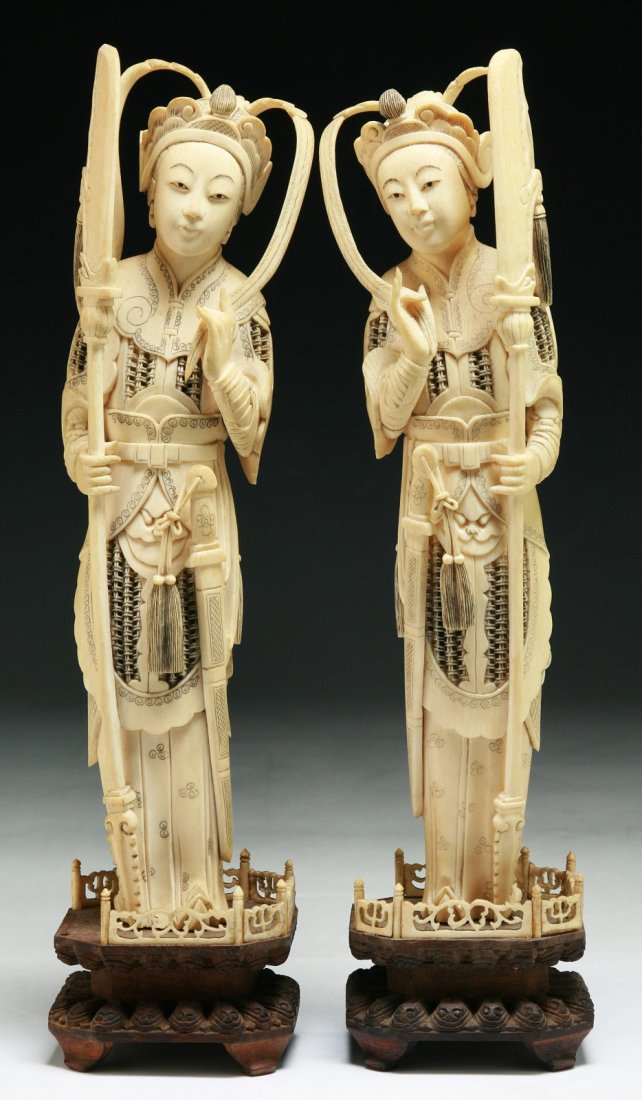 Two (2) Chinese Antique Carved Ivory Figures: Two (2) Chinese Antique Carved Ivory Figures: both carved as female figure standing in armor while carrying long blades in their hands, both presented on wood stands; Size: H: 12-1/4" (each)