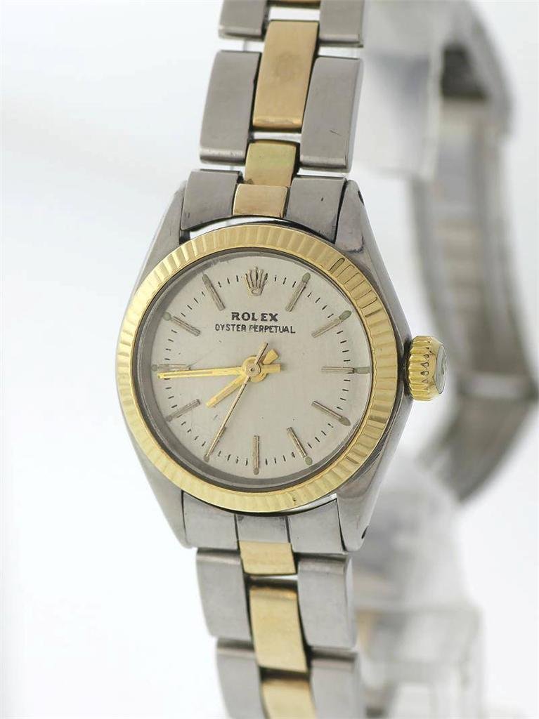 A ROLEX Oyster Perpetual Solid 14K Gold / Stainless: A ROLEX Oyster Perpetual Solid 14K Gold / Stainless Steel Women Watch: Model: 6618, Age: 1970, Jewels: 26, Caliber: 1161, Movement: Automatic, Dial Color: Silver Tone, Case Shape: Circular, Case Mater