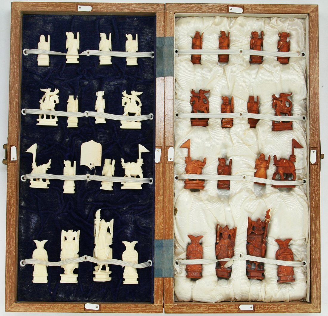 A Complete Set of Chinese Carved Ivory Chess: A Complete Set of Chinese Carved Ivory Chess: all pieces present, the opposing sides of white ivory and sienna dyed ivory are all solid carved pieces all raised on plinths, very good condition, in woo