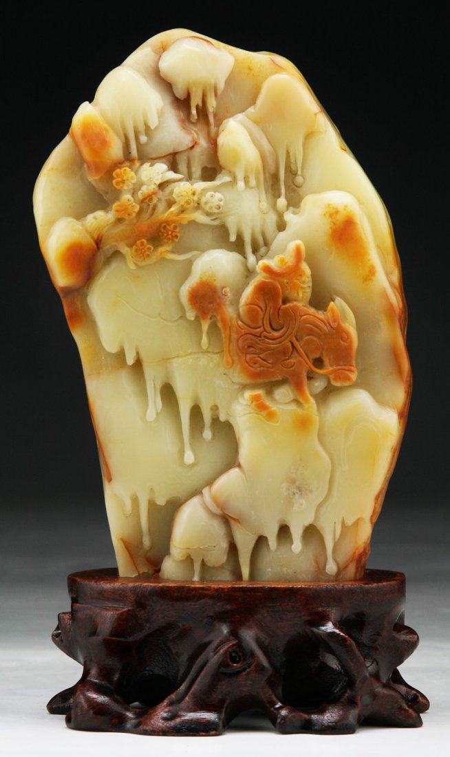 A Chinese Carved Shoushan Soapstone Boulder: A Chinese Carved Shoushan Soapstone Boulder: well carved in relief on one side as landscape scene, the reverse with further layered rockfaces, presented on a wood stand; Size: H: 6-1/4"; (overall) H: 