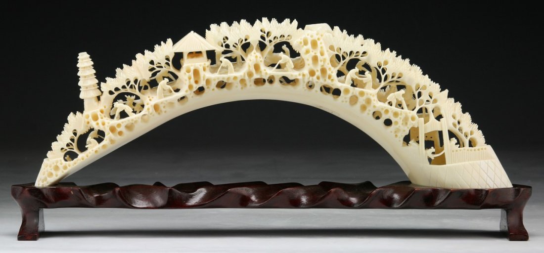 A Chinese Antique Carved Boar Ivory Tusk: A Chinese Antique Carved Boar Ivory Tusk: presented on a wood stand; Size: L: 14"