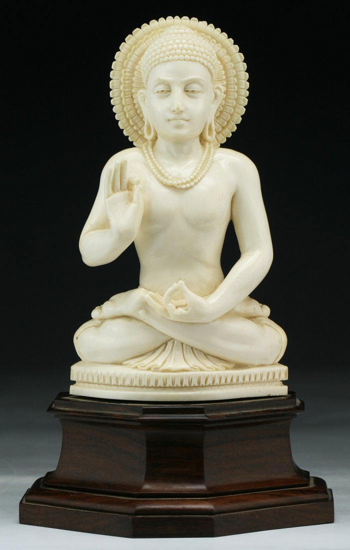 An Indian Antique Carved Ivory Buddha: An Indian Antique Carved Ivory Buddha: presented on a matching wood stand with warm brown tone; Size: H: 8-1/4" (overall)