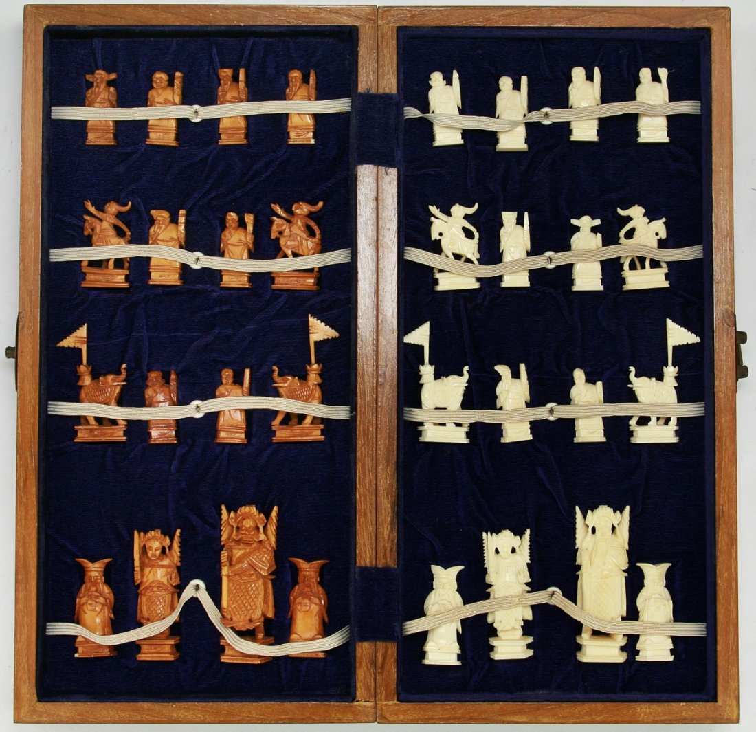A Complete Set of Chinese Carved Ivory Chess: A Complete Set of Chinese Carved Ivory Chess: all pieces present, the opposing sides of white ivory and sienna dyed ivory are all solid carved pieces all raised on plinths, very good condition, in woo
