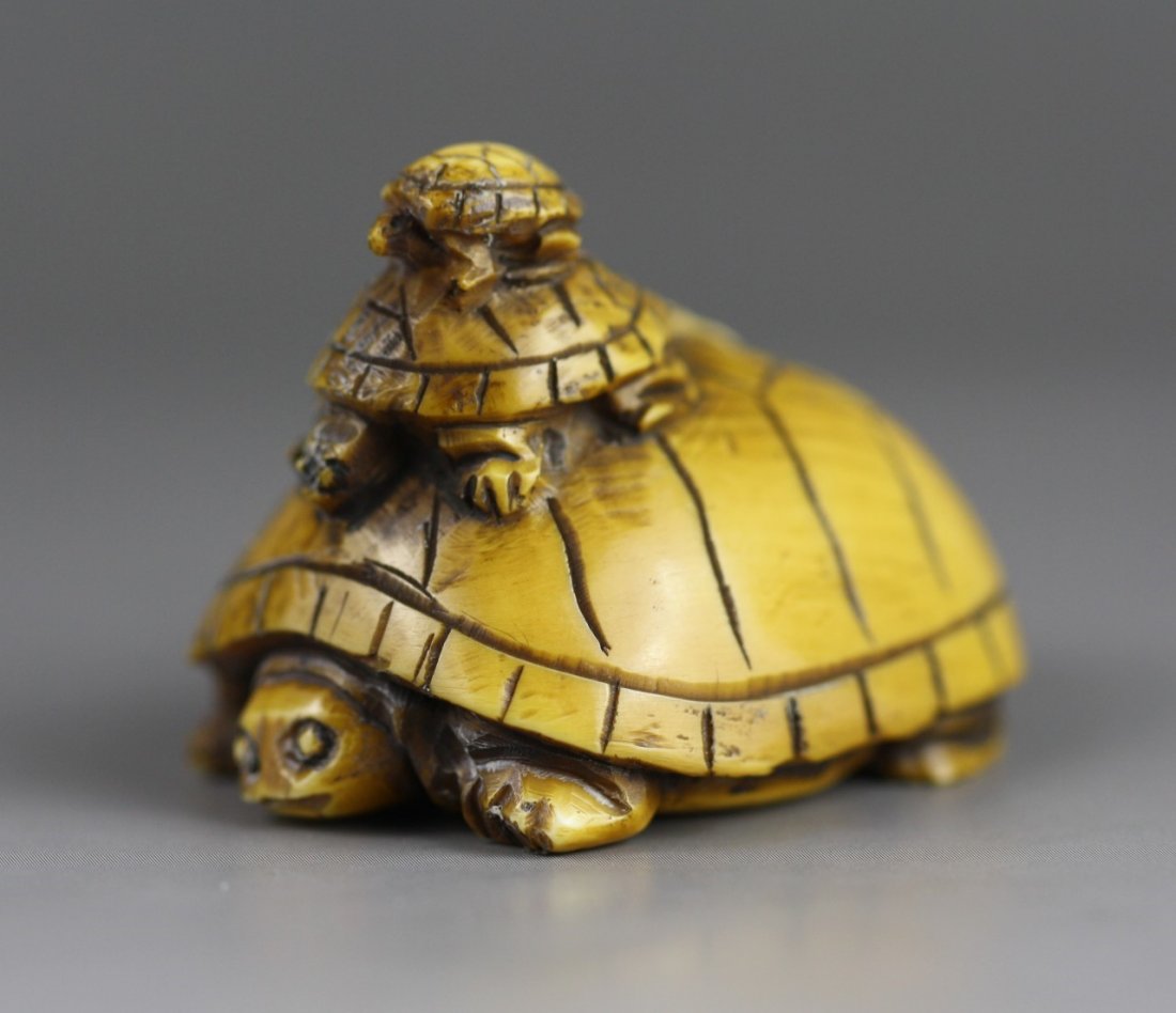 An Antique Ivory Netsuke: Turtles: An Antique Ivory Netsuke: Three highly detailed carved turtles with the biggest one on the bottom while the other two rest on its shell. Signed on the base; Size: H: 1-1/4"; L: 1-3/4"