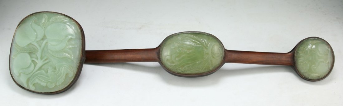 A Chinese Antique Celadon Jade Inset Ruyi Scepter: 青玉雕嵌硬木如意 A Chinese Antique Celadon Jade Inset Ruyi Scepter: wood of simple sinuous form, inset with three jade plaques carved with peach and bat