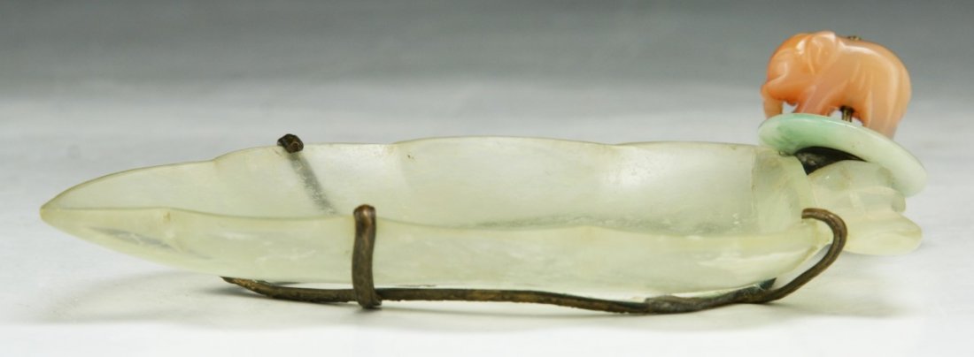 A Chinese Antique Grayish Jade Brush Washer: A Chinese Antique Grayish Jade Brush Washer: finely carved as a lily pad with a bronze fitting on the bottom that leads to a jadeite ring attached to a carnelian agate shaped pig tassel; of Qing Dynas